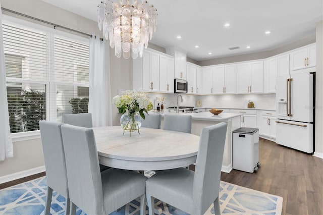 dining room featuring a chandelier, dark wood finished floors, a wealth of natural light, and recessed lighting