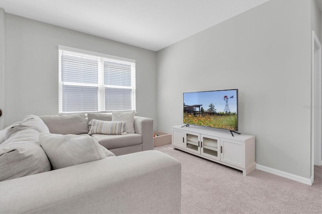 living room with light carpet and baseboards