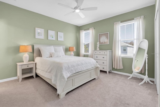 bedroom with light carpet, ceiling fan, and baseboards