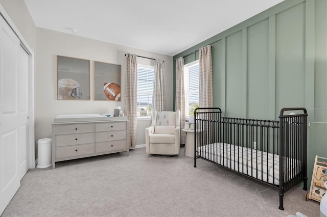 bedroom featuring a crib and carpet flooring