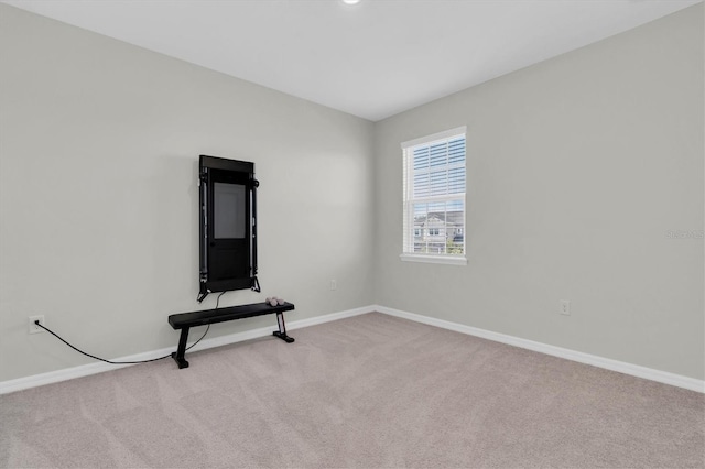 exercise room featuring carpet floors and baseboards