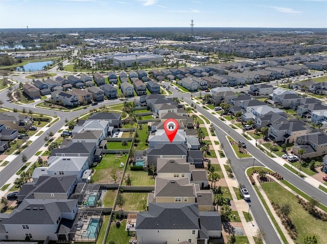 birds eye view of property with a water view and a residential view