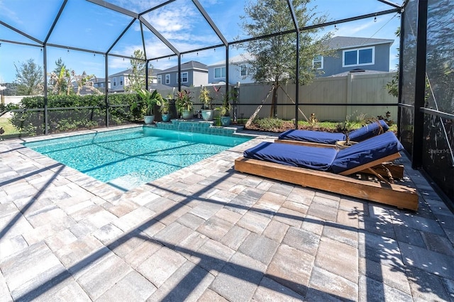 view of swimming pool featuring a patio, fence, glass enclosure, and a fenced in pool