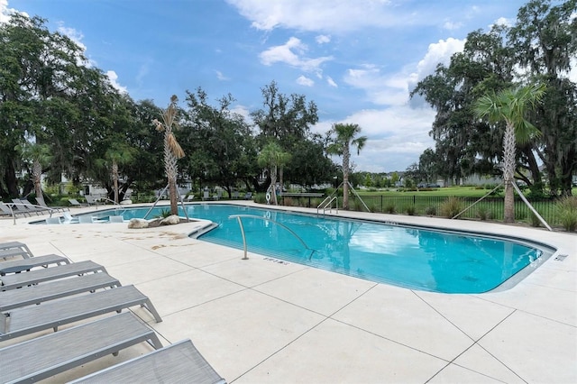 pool with fence and a patio