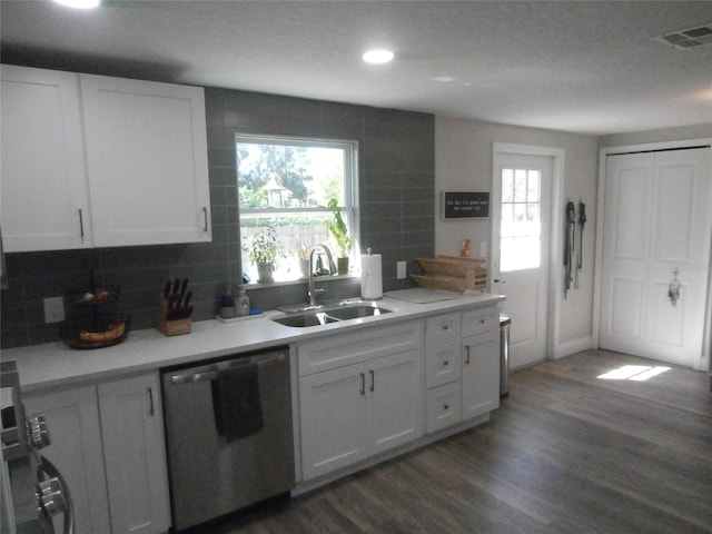 kitchen with a sink, plenty of natural light, visible vents, and stainless steel dishwasher