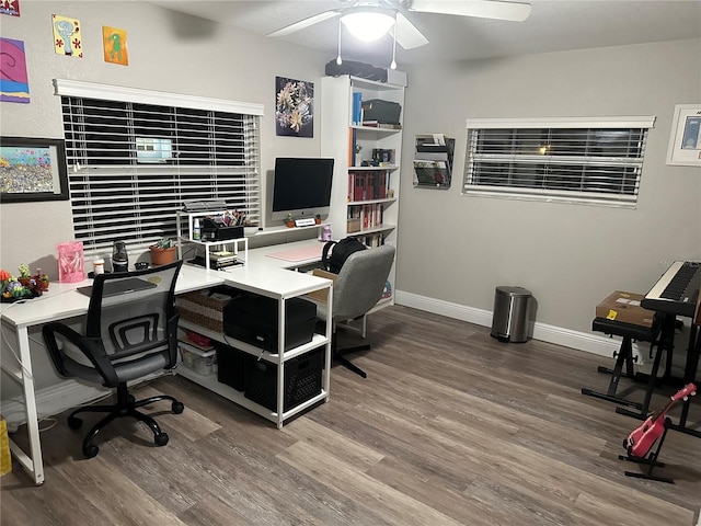 office area with a ceiling fan, baseboards, and wood finished floors