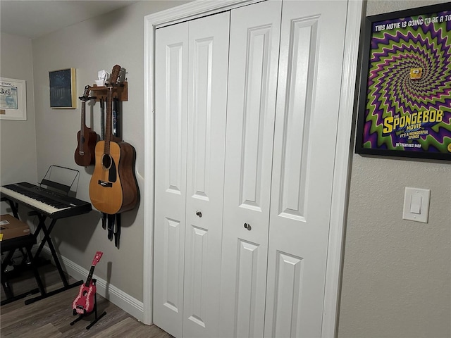 interior space featuring baseboards and wood finished floors