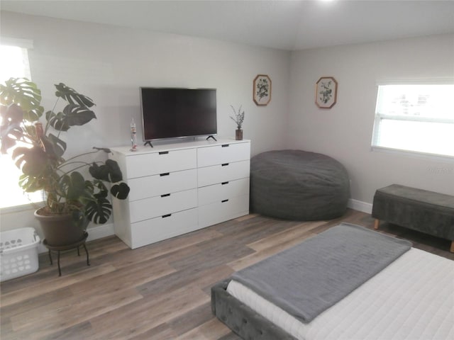 bedroom featuring baseboards and wood finished floors