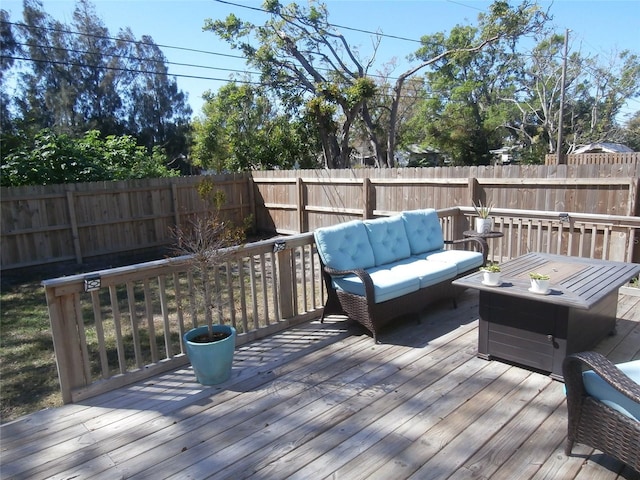 wooden terrace featuring outdoor lounge area and a fenced backyard