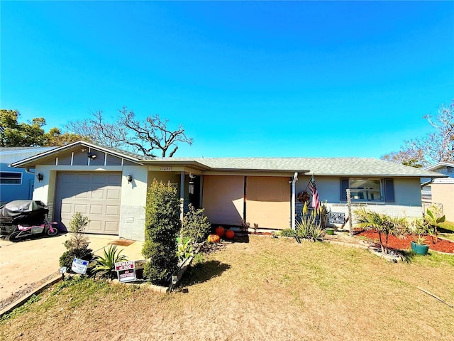 single story home with stucco siding, an attached garage, and concrete driveway