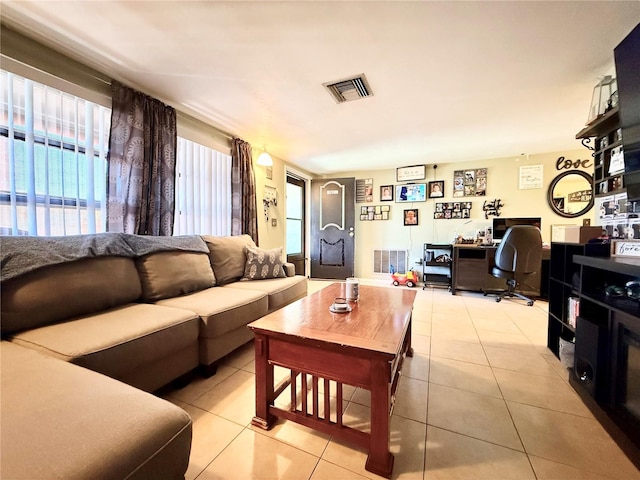 living area with visible vents and light tile patterned flooring