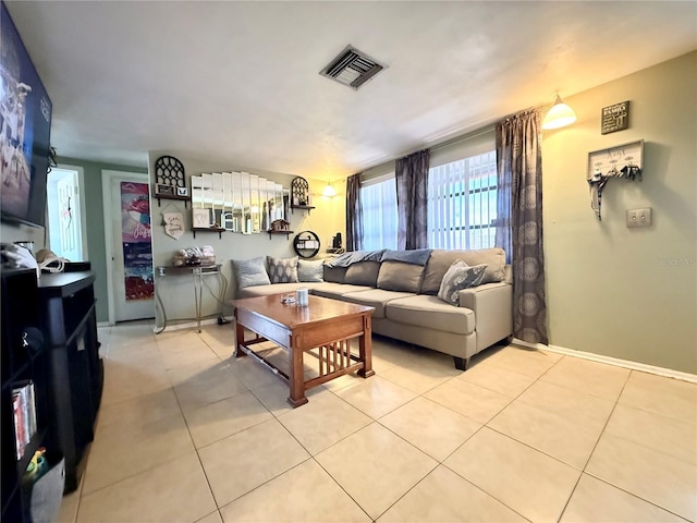 living room with light tile patterned floors and visible vents