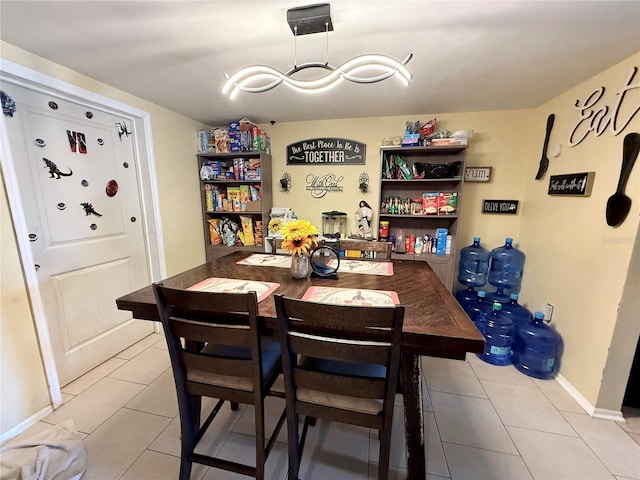 dining room with light tile patterned floors and baseboards