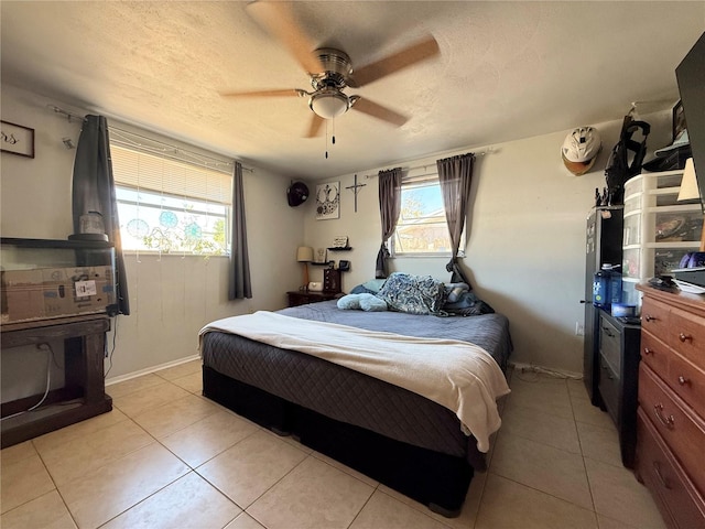 bedroom with light tile patterned flooring, a textured ceiling, and ceiling fan