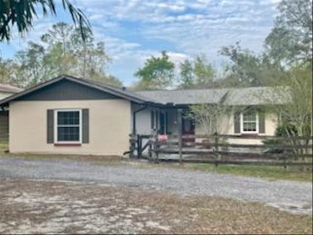 ranch-style house with fence