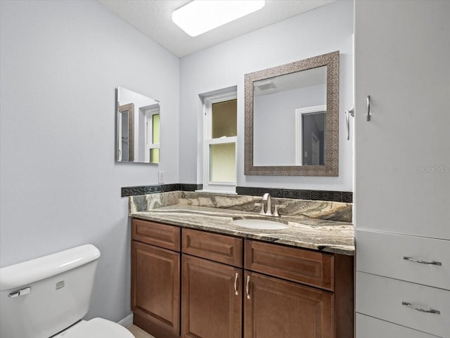 bathroom featuring vanity and toilet