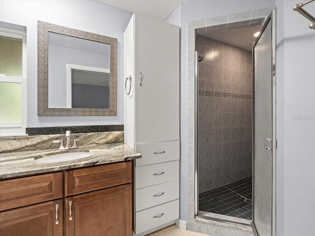 full bath featuring a shower stall and vanity