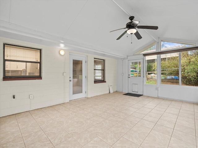 unfurnished sunroom with a ceiling fan and lofted ceiling with beams