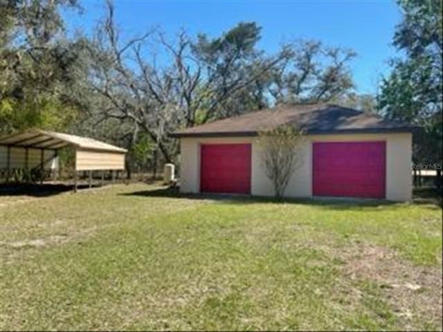 detached garage featuring a carport