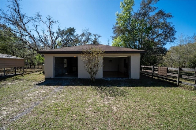 detached garage featuring fence