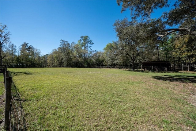 view of yard with a rural view