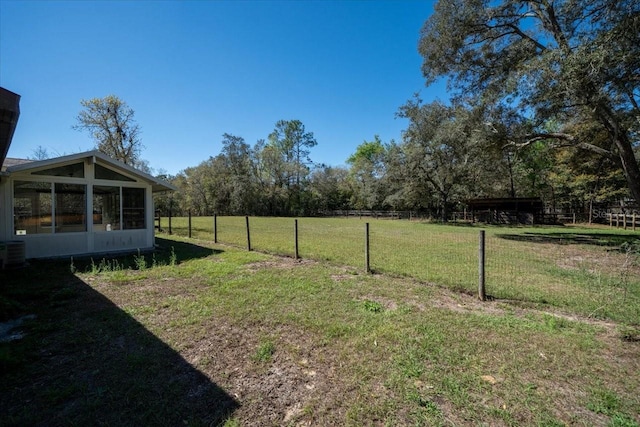 view of yard featuring cooling unit, a sunroom, and fence