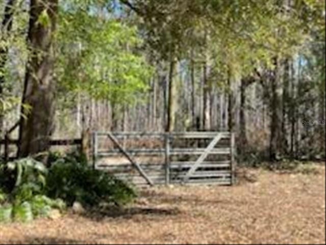 view of gate with fence