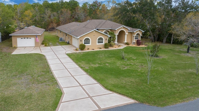 mediterranean / spanish home featuring a front lawn, driveway, and stucco siding