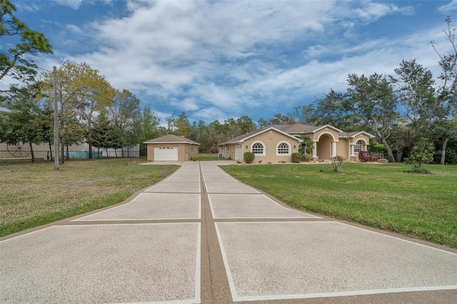 mediterranean / spanish house with a garage, an outdoor structure, a front lawn, and fence