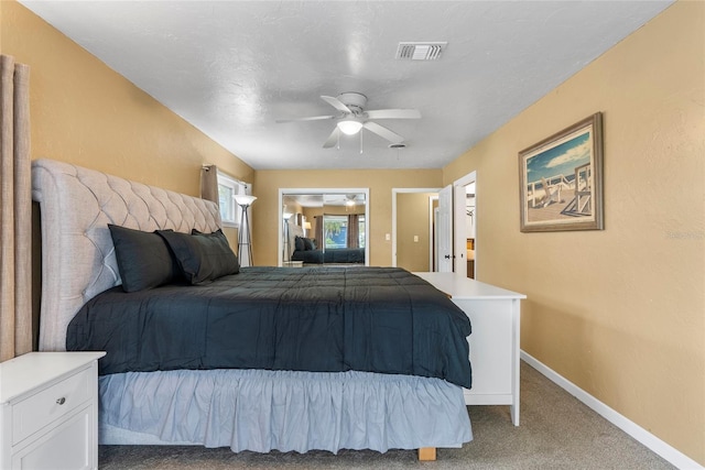 bedroom featuring ceiling fan, carpet floors, visible vents, and baseboards