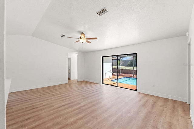 7048 Oberon Ave, Spring Hill, FL 34608 - empty room with a ceiling fan, light wood-style flooring, vaulted ceiling, and baseboards