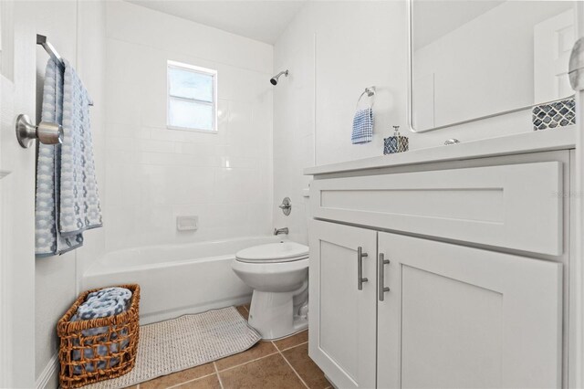 7048 Oberon Ave, Spring Hill, FL 34608 - bathroom with toilet, vanity, tile patterned flooring, and washtub / shower combination