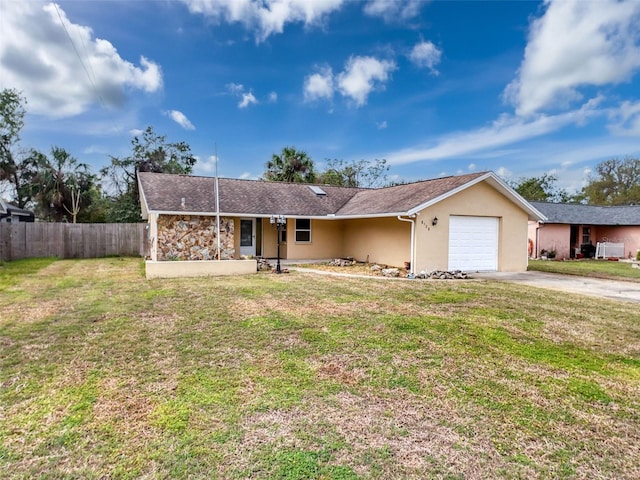 ranch-style home with a front lawn, fence, driveway, and stucco siding