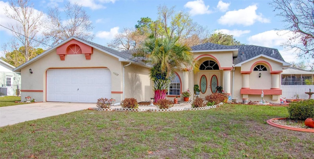 view of front of house with driveway, roof with shingles, an attached garage, a front lawn, and stucco siding