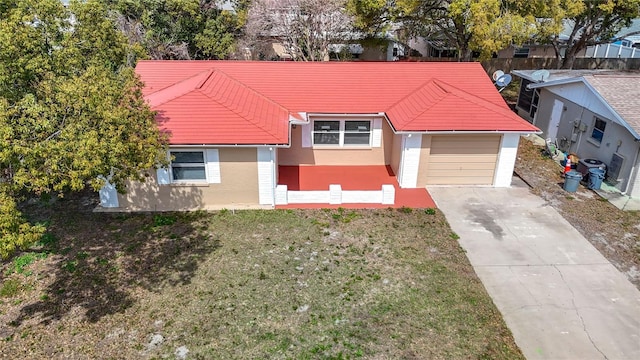 ranch-style house with a front yard, driveway, and stucco siding