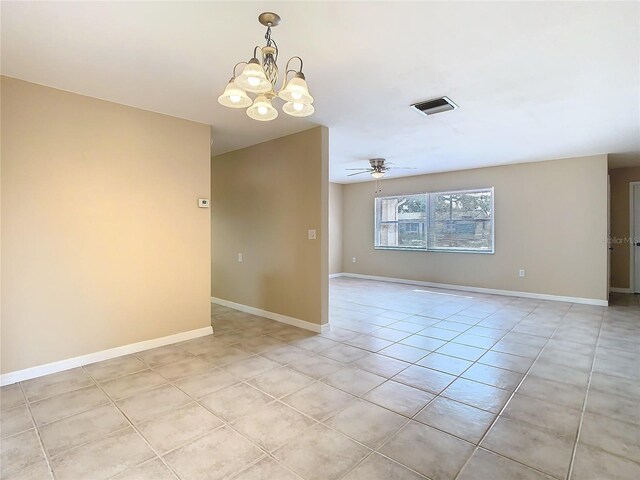 unfurnished room featuring ceiling fan with notable chandelier, visible vents, baseboards, and light tile patterned floors