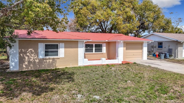 ranch-style home with a front lawn, brick siding, driveway, and an attached garage