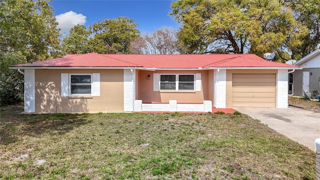 ranch-style house featuring an attached garage, driveway, a front lawn, and stucco siding