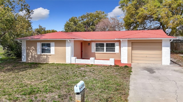 single story home featuring a front yard, concrete driveway, an attached garage, and stucco siding