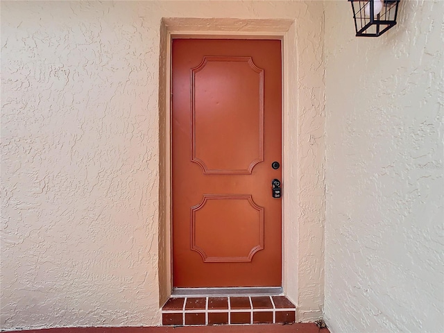 property entrance featuring stucco siding