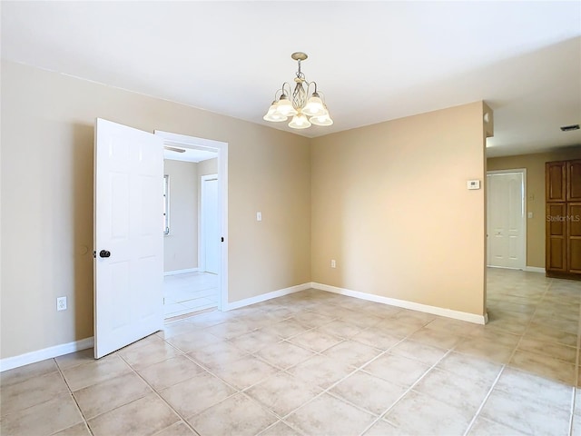 spare room featuring light tile patterned floors, visible vents, baseboards, and an inviting chandelier