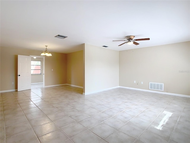 unfurnished room with ceiling fan with notable chandelier, light tile patterned flooring, visible vents, and baseboards