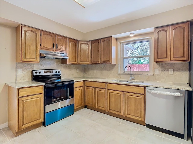 kitchen featuring brown cabinets, electric range, a sink, under cabinet range hood, and dishwashing machine