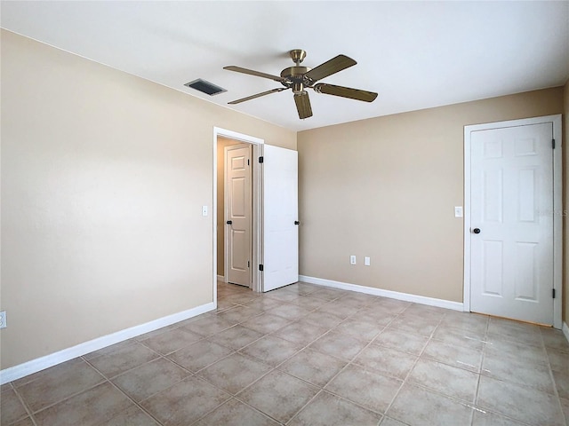 unfurnished room with light tile patterned floors, baseboards, visible vents, and ceiling fan