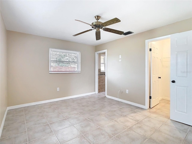 unfurnished bedroom with a ceiling fan, visible vents, baseboards, and light tile patterned flooring