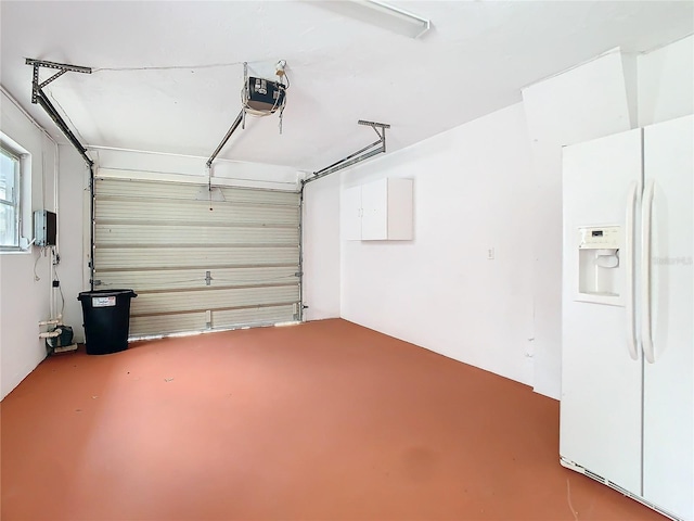 garage with white fridge with ice dispenser and a garage door opener