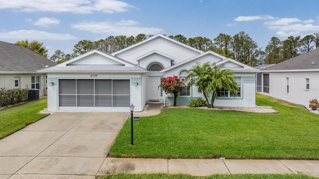 ranch-style house with an attached garage, a front lawn, and stucco siding