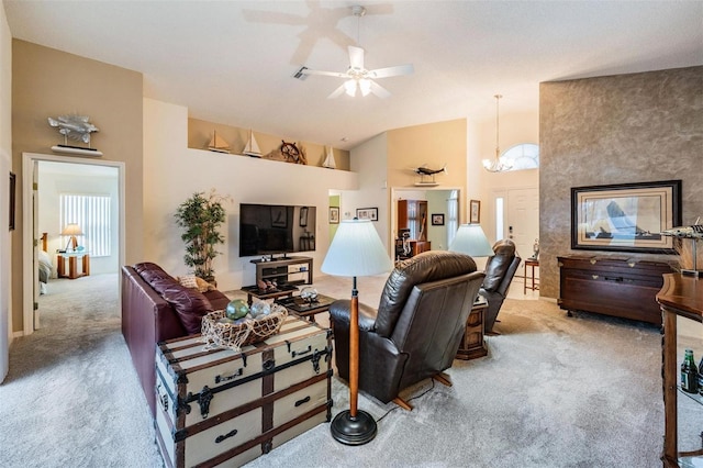 living room with ceiling fan with notable chandelier, carpet floors, and a high ceiling