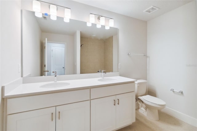 bathroom with toilet, visible vents, a sink, and tiled shower