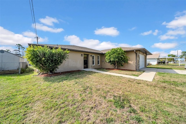 exterior space with fence, a yard, stucco siding, concrete driveway, and a garage